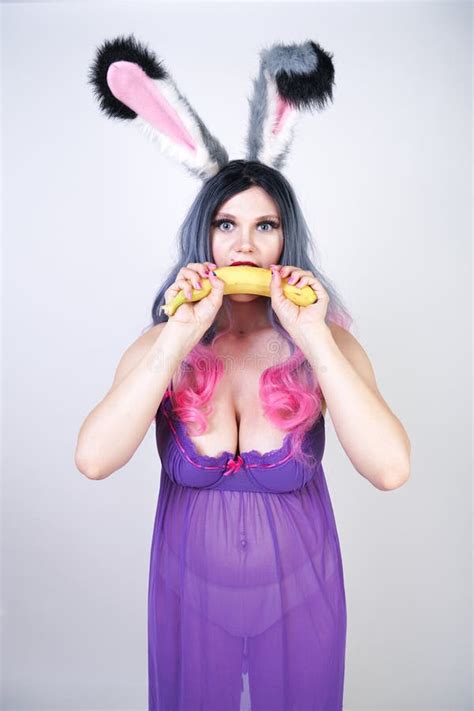 Erotic Banana And Donut In The Hands As A Symbol Of The Penis And Vagina Isolated On A White