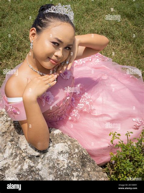 A Philippine Princess Wearing A Pink Dress And A Crown And Sitting