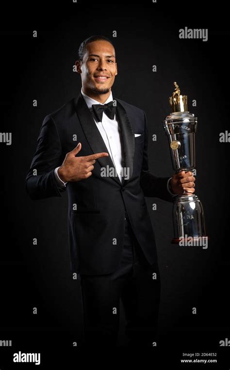 Liverpool's Virgil van Dijk poses with his PFA Player of the Year award ...