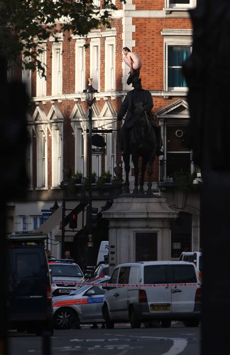 Naked Man Sits On Statue In Central London For Three Hours