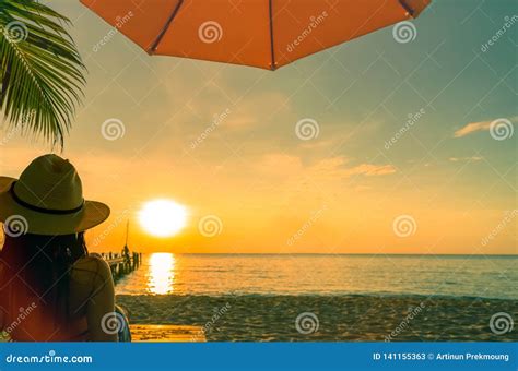 Sexy Enjoy And Relax Woman Wear Bikini Lying And Sunbathing On Sunbed At Sand Beach At Paradise