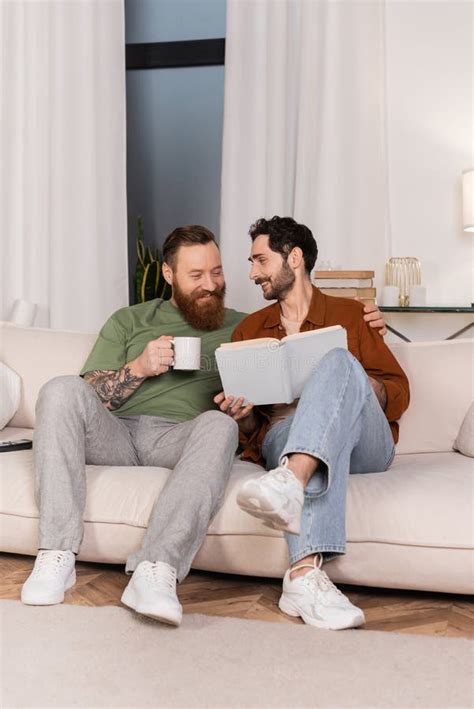 Cheerful Same Sex Couple Holding Coffee Stock Image Image Of Happy Couch