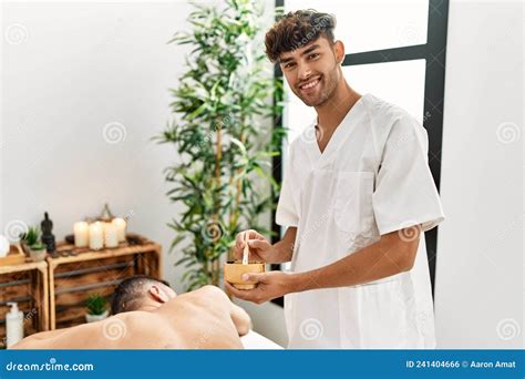 Two Hispanic Men Physiotherapist And Patient Having Skin Back Treatment