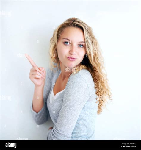 Take A Look A Pretty Vivacious Blonde Looking At You And Pointing Away Stock Photo Alamy