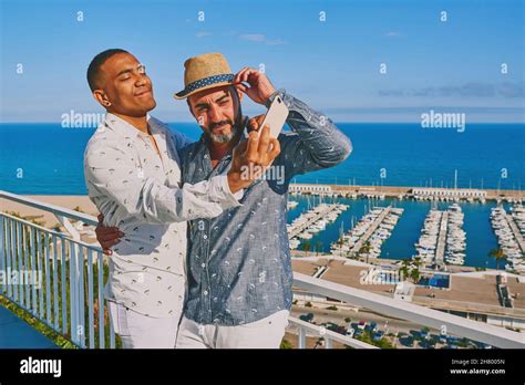 A Gay Couple Using A Mobile Phone Stock Photo Alamy