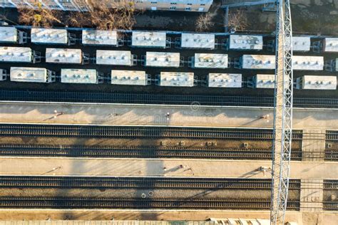 Top Down Aerial View Of Many Cargo Train Cars On Railway Tracks Stock