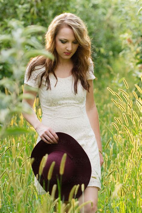 Young Woman Walks Through Tall Grass By Stocksy Contributor Tana Teel Stocksy