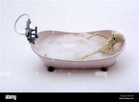Humorous Scene Of Naked Skeleton Taking A Bubble Bath During Snow Storm