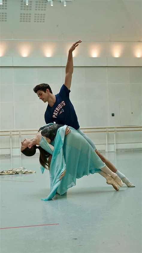 two people doing acrobatic tricks in a large room