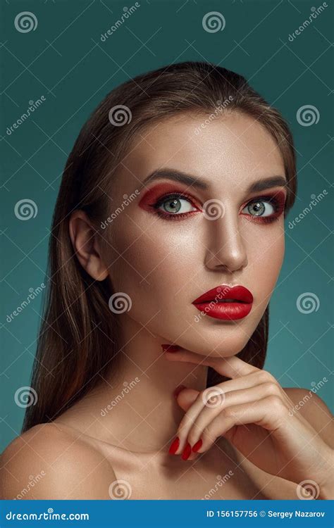 Close Up Glamour Portrait Of A Beautiful Half Naked Model With Bright Make Up Posing Over A Gray