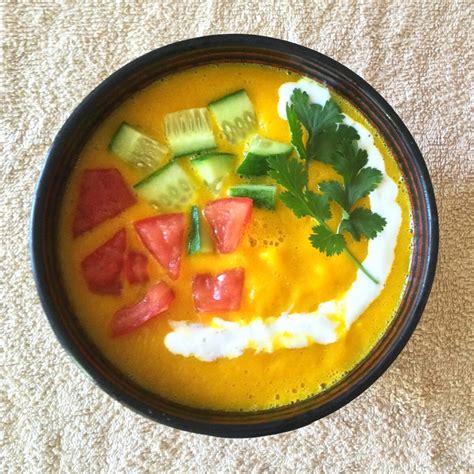 Spicy Pumpkin Soup Topped With Fresh Garnish and Greek Yogurt