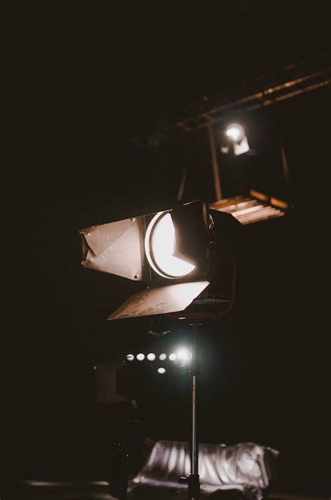 Bright spotlight glowing in dark room · Free Stock Photo