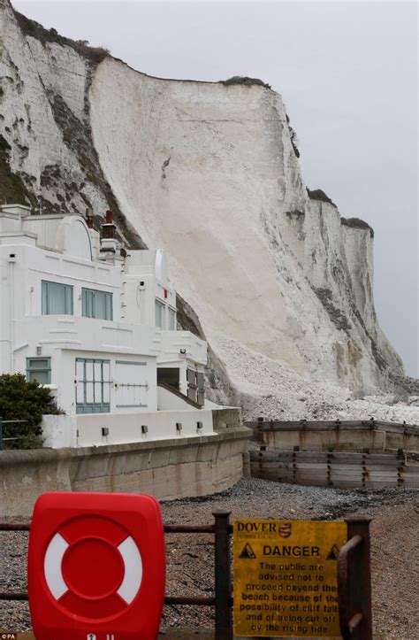 Huge Section Of White Cliffs Of Dover Falls Into The Sea Just Yards From Row Of Beach Front