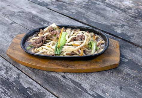 Hot Delicious Beef Udon Noodle Hot Plate On An Old Teak Wood Table Stock Photo Image Of Dish
