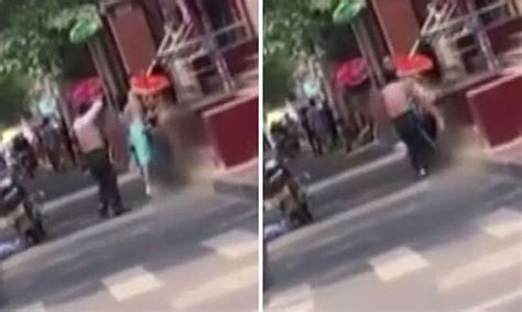 Video Shows Two Chinese Men Strip Off In The Street To Give Clothes To Naked Woman Daily Mail