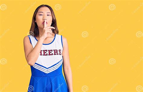 Young Beautiful Chinese Girl Wearing Cheerleader Uniform Asking To Be