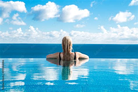 Beautiful Blonde Woman Model With Wet Hair And Elegant Makeup Sitting In A Pool With Amazing