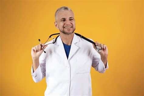 Premium Photo Cheerful Mature Doctor Posing And Smiling At Camera Healthcare And Medicine
