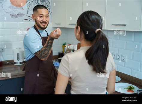 Asian Man Telling Something To A Woman In The Kitchen Stock Photo Alamy