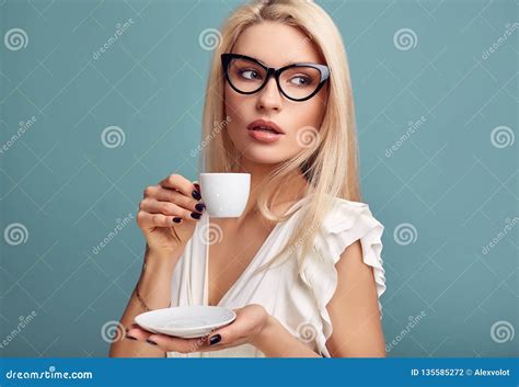 Gorgeous Sensual Blonde Woman In White Dress With Cup Of Coffee Stock