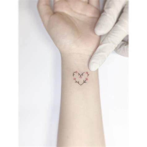 Flower Heart Tattoo Located On The Wrist Minimalistic