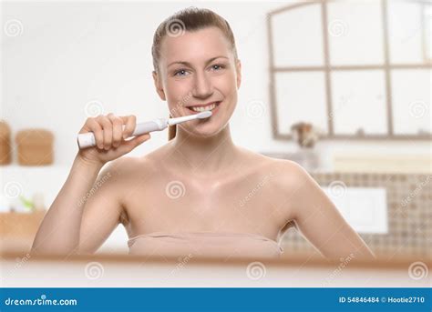 Smiling Woman Using An Electric Toothbrush Stock Photo Image Of Health Naked 54846484