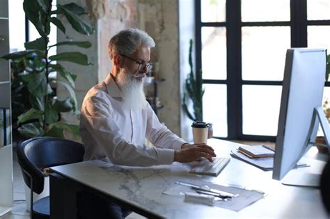Premium Photo Mature Businessman Working On Computer In Modern Office
