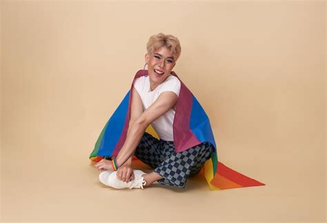 Free Photo Youth Asian Transgender Lgbt With Rainbow Flag On Shoulder Isolated Over Nude Color