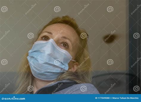 Italian Blonde Woman With Protective Mask Forced To Stay Closed At Home For The Quarantine