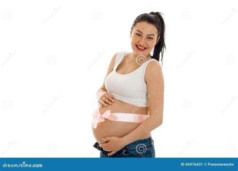Cheerful Pregnant Brunette Woman With Pink Tape On Her Big Belly Posing Isolated On White