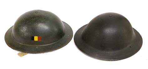 Lot 231 - Two British Brodie Helmets, one with leather