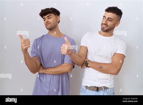 Homosexual Gay Couple Standing Over White Background Looking Proud Smiling Doing Thumbs Up