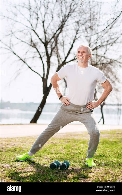 Enthusiastic Mature Man Stretching In Park Stock Photo Alamy