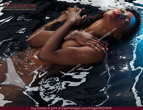 Beautiful Black African American Woman Lying In Water Half Naked Sensual Portrait Stock Photo