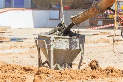 Concrete Mixer Truck Pouring Liquid Concrete Into The Tower Crane