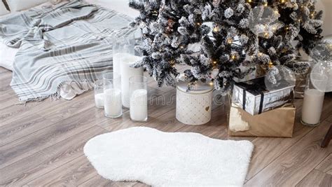 Christmas Tree With Presents And Lights In Light And Airy Living Room