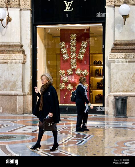 Chic Stylish Smart Elegant Women Passing A Louis Vuitton Designer