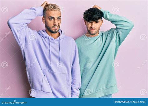 Homosexual Gay Couple Standing Together Wearing Casual Clothes Confuse And Wondering About