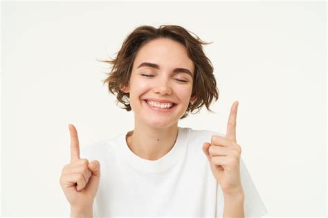 Free Photo Close Up Portrait Of Happy Smiling Brunette Girl Pointing Fingers Up Laughing