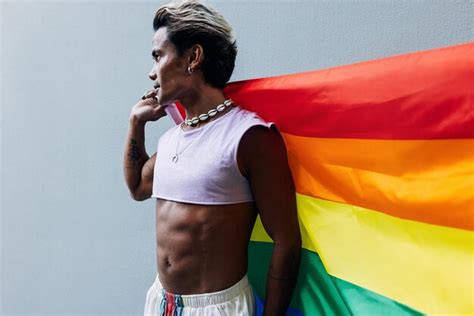 Premium Photo Gay Man With Rainbow Flag Against Wall