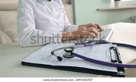 doctor typing medical records  computer stock photo