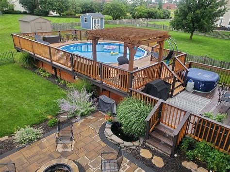 An Aerial View Of A Backyard With A Swimming Pool And Hot Tub In The Middle