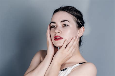 Premium Photo Portrait Of A Beautiful Woman Head Is Turned To The Side Naked Bust Hands Near