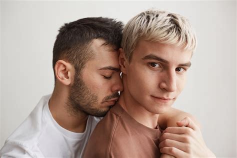 Premium Photo Close Up Portrait Of Loving Gay Couple Embracing And Looking At Camera While