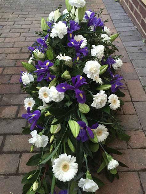 White Lillies Gerberas And Carnations With Blue Iris Casket Spray