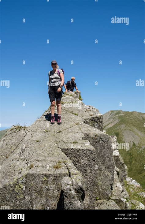 Hikers Scrambling On Llech Ddu Spur Or Crib Lem On Carnedd Dafydd In