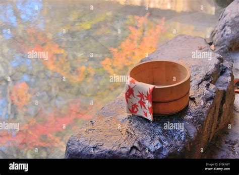 Open Air Hot Spring And A Wooden Pail With Autumn Foliage Stock Photo Alamy