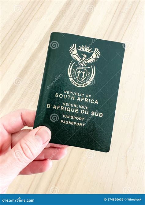 Hand Holding a South African Passport Stock Image - Image of