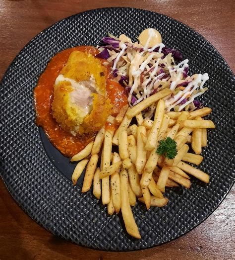 Pollo Cordon Bleu Con Papas Fritas Y Ensalada En El Lugar Foto Premium