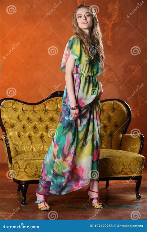 Attractive Slender Blonde Model Posing And Standing In Full Height On High Heels Stock Image